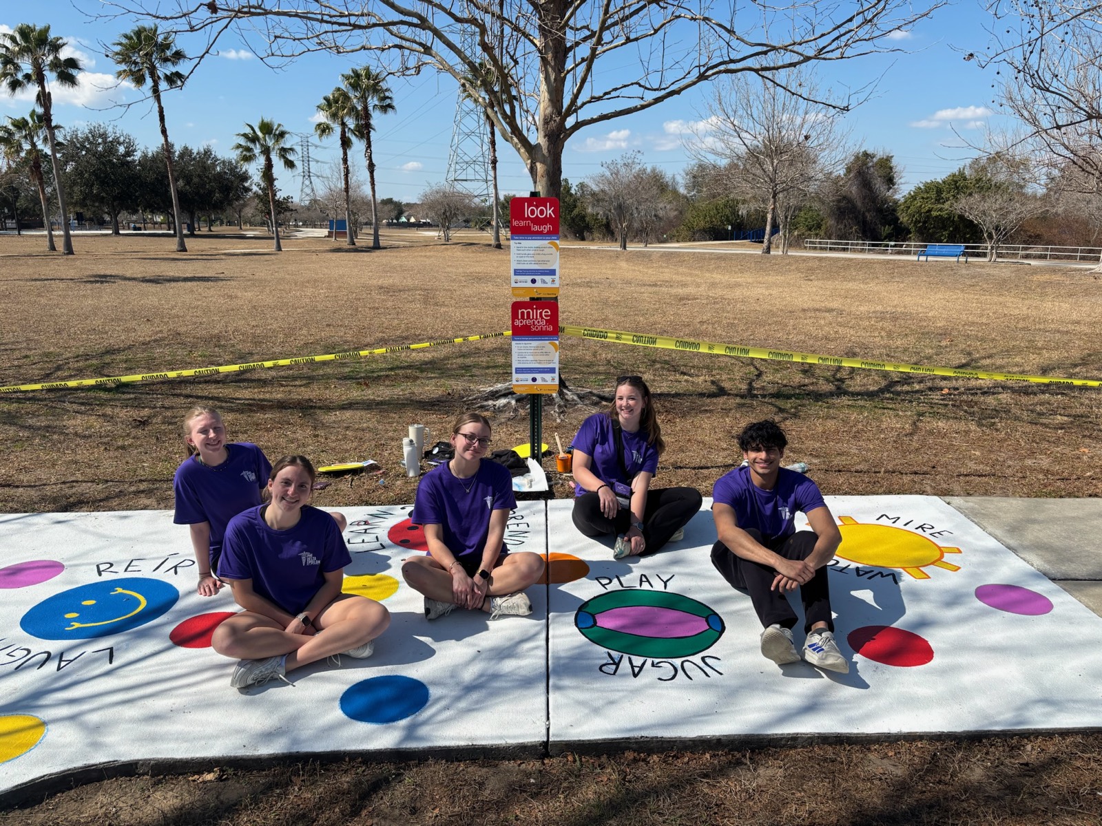 Members in purple PhiDE shirts at a Children's Miracle Network event
